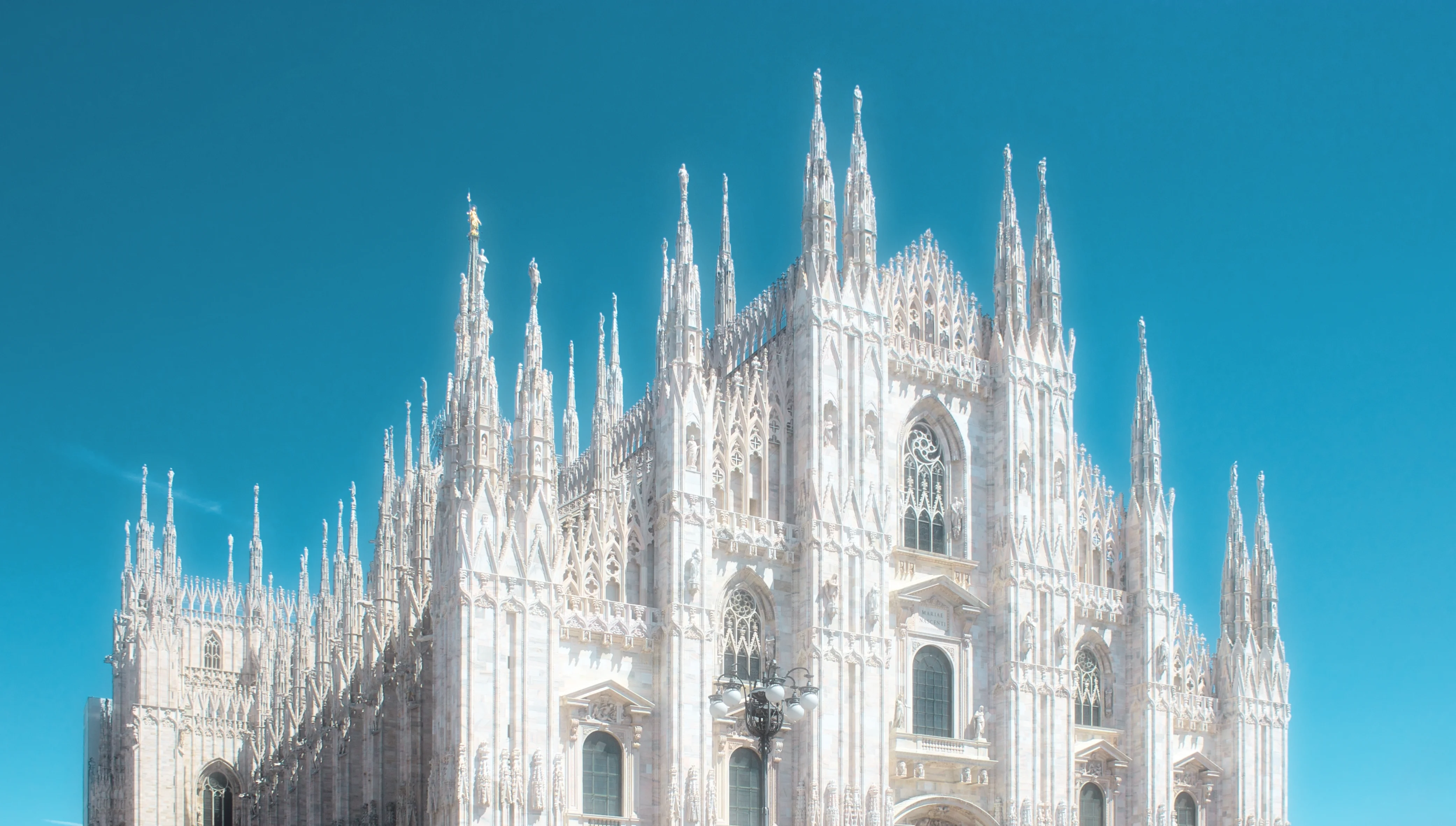 Photo of the gothic cathedral &ldquo;Dumo di Milano&rdquo; in Italy. Epic, bright, glowing, and radient.